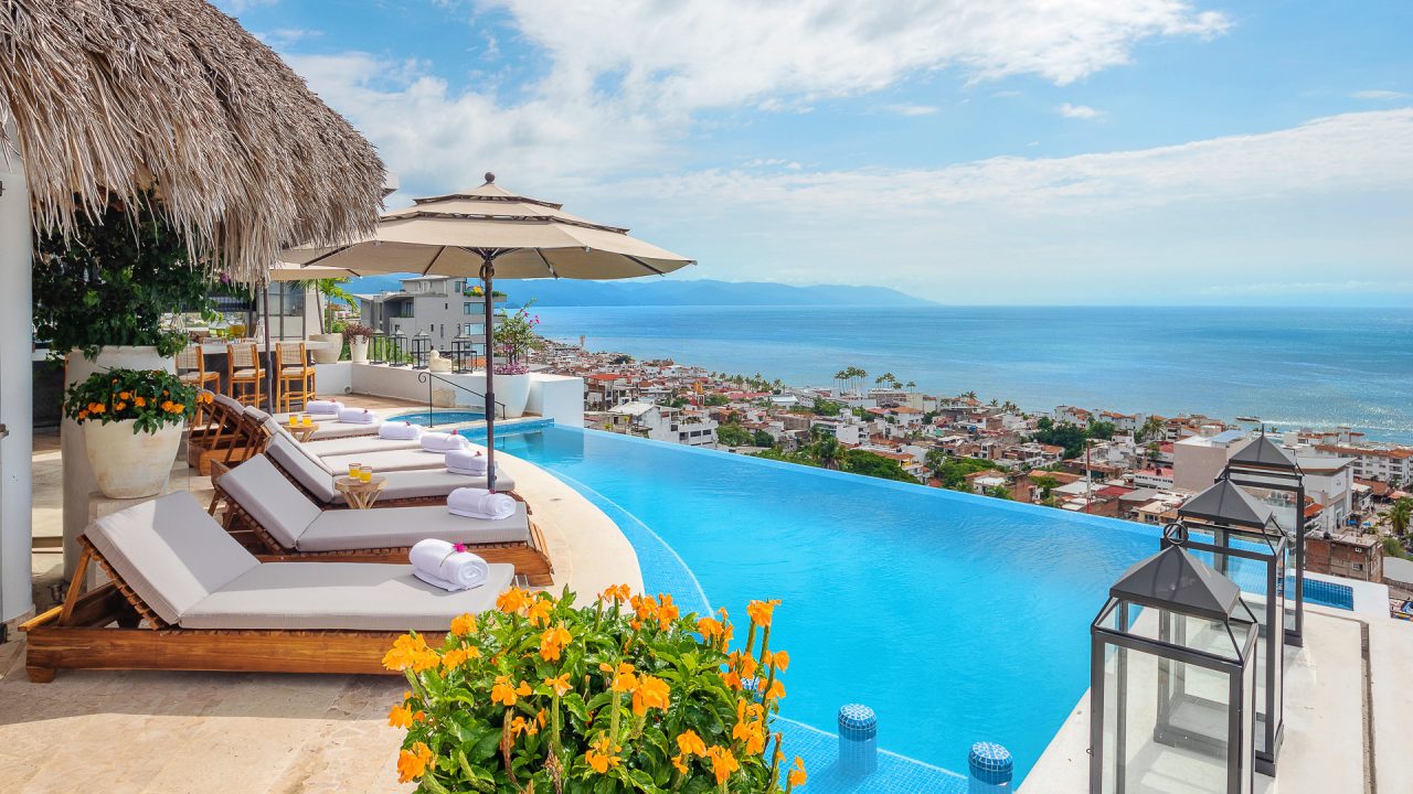 Infinity pool and loungers overlooking Puerto Vallarta and Banderas Bay