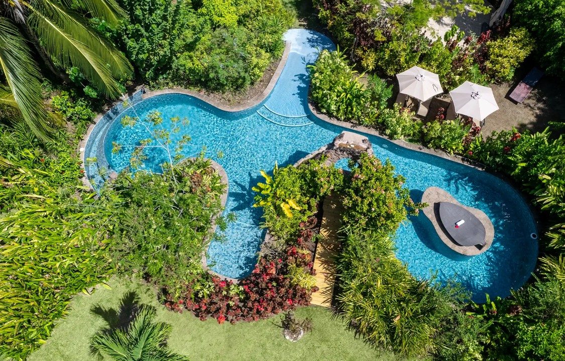 Aerial view of a winding pool amid lush tropical gardens in St. Lucia